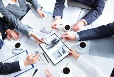 Above view of business team discussing papers at meeting